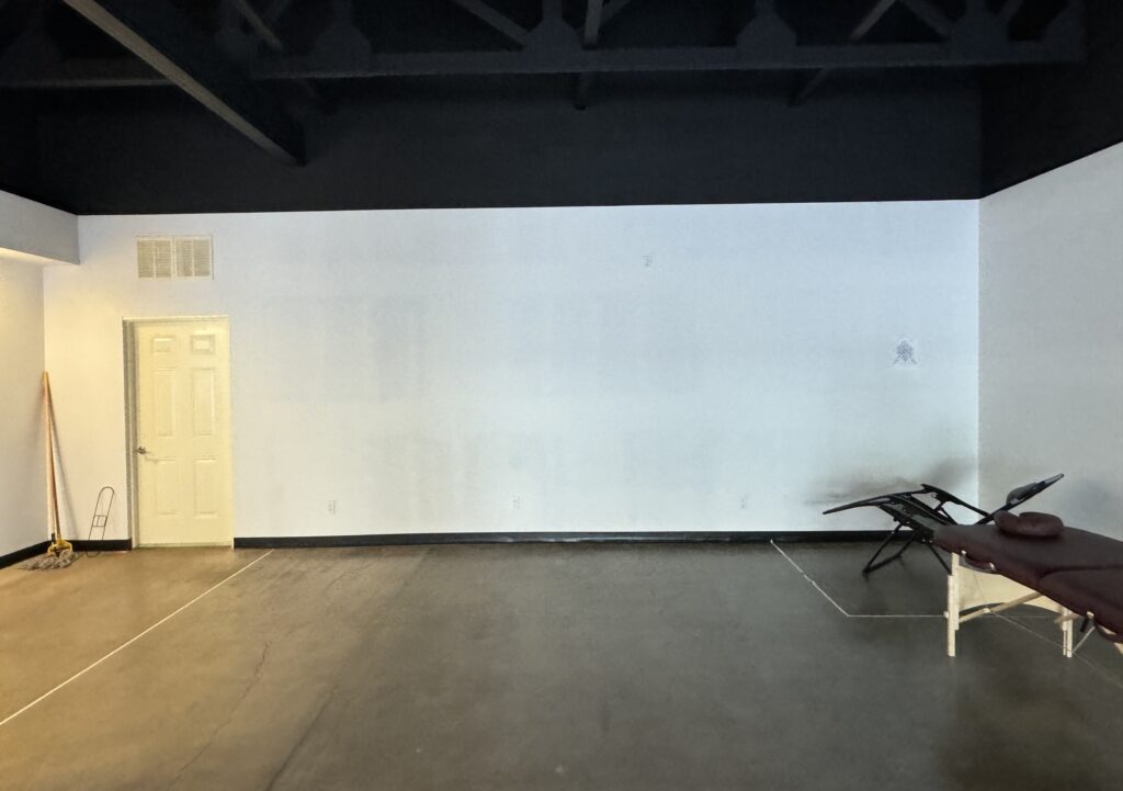 Photo of blank wall before starting custom Maui mural project.