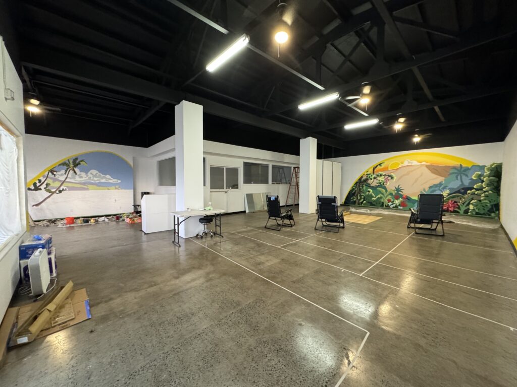 A Haleakala sunrise mural and nroth shore Maui mural in Makawao town at Maui Community Acupuncture.