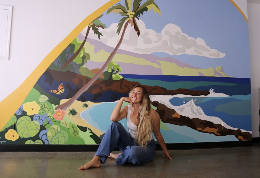 Maui Artist poses with her complete north shore Maui ocean scene mural.